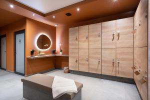 a dressing room with wooden cabinets and a mirror at Les Chalets de Joy in Le Grand-Bornand