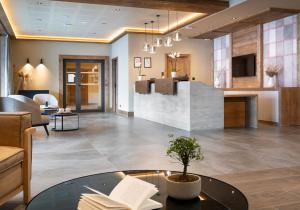 a lobby with a table with books on it at Les Chalets de Joy in Le Grand-Bornand