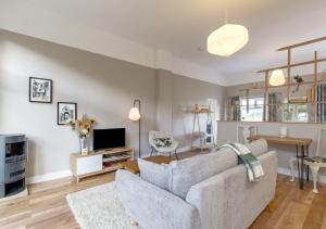 a living room with a couch and a tv at Little Oldbury in Hevingham