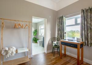 a home office with a desk and a window at Little Oldbury in Hevingham