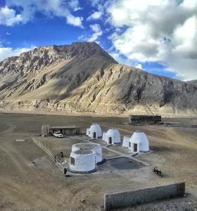 a group of white tents in front of a mountain at Spiti Eco Domes in Kaza