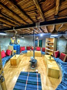 a large living room with blue and red furniture at Spiti Eco Domes in Kaza