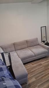 a couch sitting in a living room next to at Magnifique Studio pas loin centre-ville in Reims