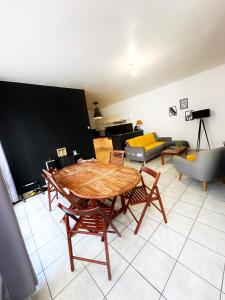 a living room with a wooden table and chairs at Nice flat close to Stade de France & Paris' heart in Saint-Denis