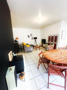 a living room with a table and a couch at Nice flat close to Stade de France & Paris' heart in Saint-Denis