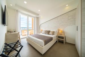 a bedroom with a bed and a brick wall at Poseidon Rooms in Cagliari