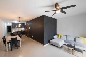 a living room with a couch and a ceiling fan at Blossom Bliss apartment in Msida