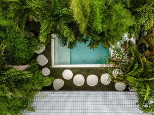 an overhead view of a pool with areath of plants at Berapi Villa by EVDEkimi - Elegant 3BR Ubud Home with Pool & Kitchen near Central Ubud in Ubud +34 photos