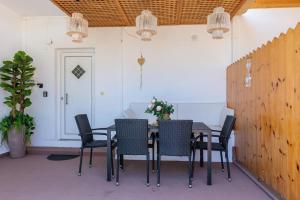 a dining room table and chairs in a room at Spot on the sea in Archangelos