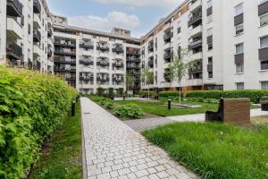 a walkway in front of a large apartment building at Osiedle Avia Modern Apartment in Krakow