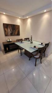 a dining room with a table and two chairs at Apartamento Farolandia in Aracaju