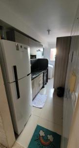 a kitchen with a white refrigerator and a counter top at Apartamento Farolandia in Aracaju