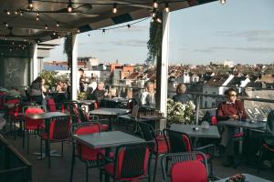 a restaurant with tables and chairs on a balcony at Sofitel Brussels Europe in Brussels