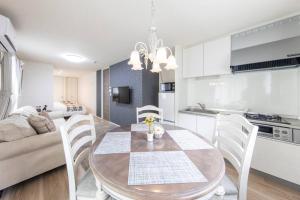 a kitchen and dining room with a table and chairs at Logement Aile 101 in Takasaki