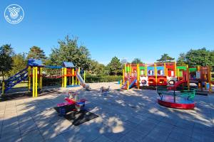 a playground with colorful play equipment in a park at RESIDENCE BAIA RILKE in Sistiana