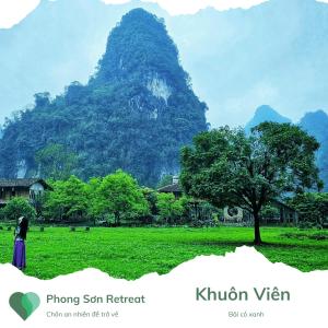 a person standing in a field in front of a mountain at Phong Sơn Retreat - Hữu Lũng, Lạng Sơn in Lạng Sơn
