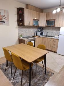 a kitchen with a wooden table and chairs at The View in Sandanski