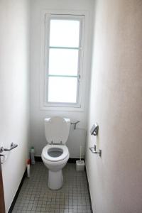 a bathroom with a toilet with a window at Maison de 3 chambres avec jardin amenage a Montbron in Montbron