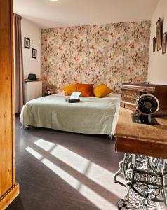 a bedroom with a bed with a floral wall at Auberge de Chanteuges in Chanteuges