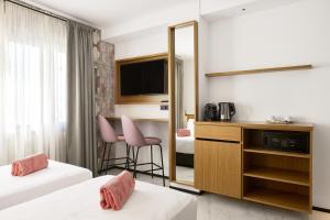 Łóżko lub łóżka w pokoju w obiekcie Stic Urban Hotel & SPA