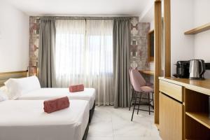 Łóżko lub łóżka w pokoju w obiekcie Stic Urban Hotel & SPA