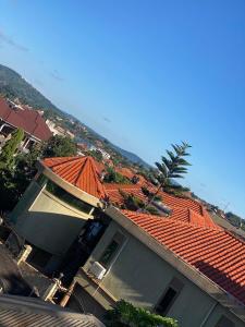 ein Haus mit einem orangenen Dach mit einer Palme in der Unterkunft HA Luxury Air B&B in Kampala