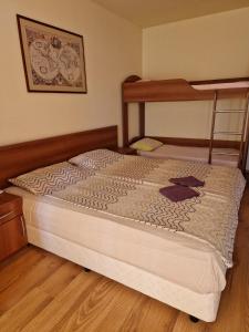 a bed in a bedroom with a bunk bed at Apartment Kalin complex Aurelia-RAVDA in Nesebar