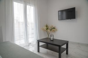 a bedroom with a table and a tv on a wall at Central apartment near to Acropolis area in Athens