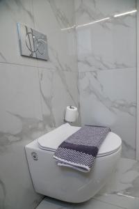 a bathroom with a toilet with a towel on it at Central apartment near to Acropolis area in Athens