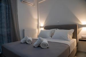 a bedroom with a bed with towels on it at Central apartment near to Acropolis area in Athens