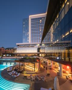 a hotel with a swimming pool and a building at Loews Arlington Hotel in Arlington