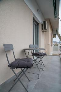 two chairs and a table on the side of a building at Central apartment near to Acropolis area in Athens