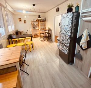 a kitchen and dining room with a table and a refrigerator at Boogalow Hostel in Gijón