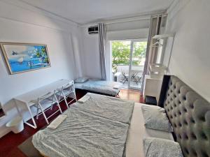 a bedroom with a bed and a living room at Obrigado Lisboa in Lisbon
