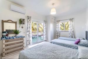 a bedroom with two beds and a mirror at Villa Paradis - Casa Completa in Pêra +37 photos