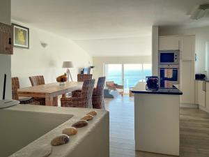 a kitchen and living room with a table and a dining room at 414 Casa Colina Mar in Salema