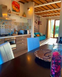 a kitchen with a wooden table and a dining room at Agriturismo La Corte del Sole in Siena