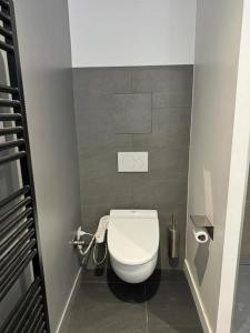 a small bathroom with a white toilet in a stall at No Matter Stay - Chic and classy - Arc de Triomphe in Paris