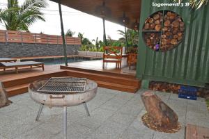 a patio with a grill next to a building at Loc974 Les Cocotiers in Saint-Leu