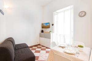 a living room with a table and a couch at MARNE IV - Cosy 2 pièces en plein centre de Menton in Menton