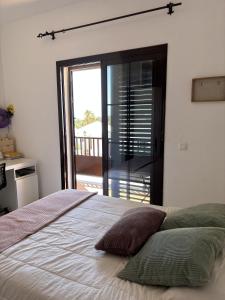 a bedroom with a large bed and a balcony at Villa Palmeras in Costa Teguise +21 photos