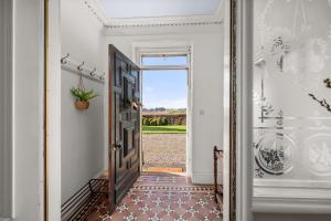 a hallway with a door leading to a yard at The Farmhouse - Countryside Escape with Hot Tub in Broughty Ferry