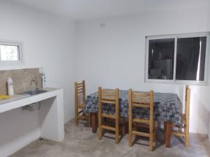 a kitchen with a table with chairs and a sink at Timo Fishing in Victoria