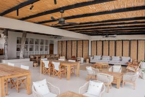 a large room with wooden tables and chairs at GAIA Alaçatı BY THE SEA - Adult Only in Cesme