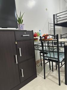 a kitchen with a table and a dining room at Family room Casa Mia at SMDC Styles Residence Tower A in Iloilo City