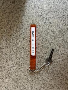 a key chain on top of a counter with a zipper at ホテルアイエス in Yokohama