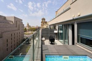 a balcony with a swimming pool on a building at Catalonia Square 4* Sup in Barcelona