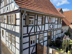 an old house with white and black trim at Altes Grabenhöfchen in Nordheim vor der Rhön