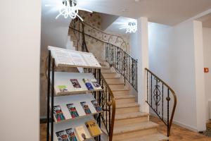 a staircase in a house with books at Honeybee Properties Winningen in Winningen
