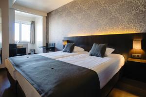 Postel nebo postele na pokoji v ubytování Hotel Ambassadeur